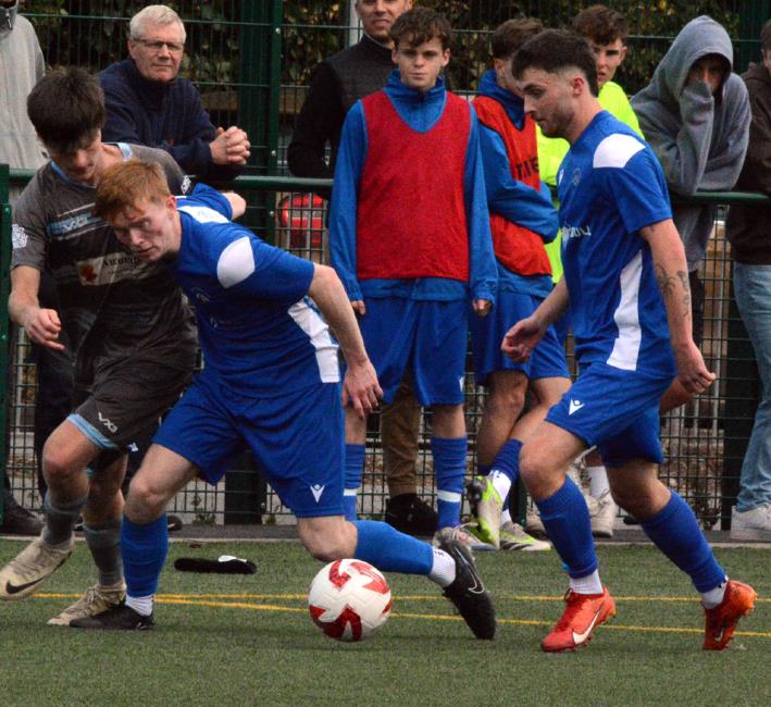 Harvey Dalton battles for possession as Merlins Bridge beat Pembrey to progress. Picture Gordon Thomas 